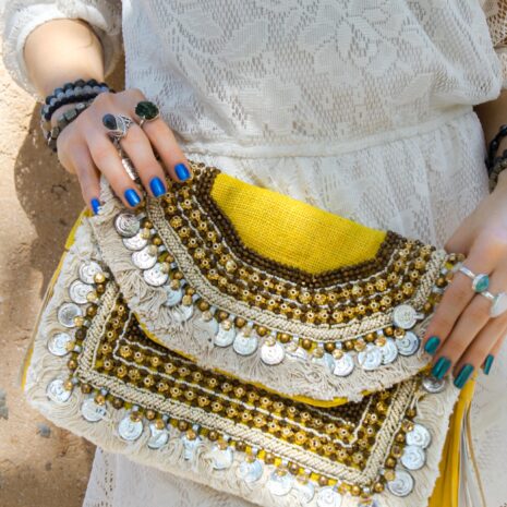 Model Wearing Sterling Silver Gemstone rings and Hand Embroidered Clutch Bag